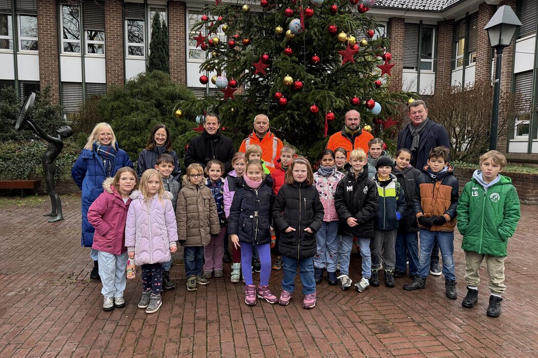 Selbstgebasteltes im Lichterglanz.Grundschulkinder schmücken Weihnachtsbaum im Rathaus-Innenhof